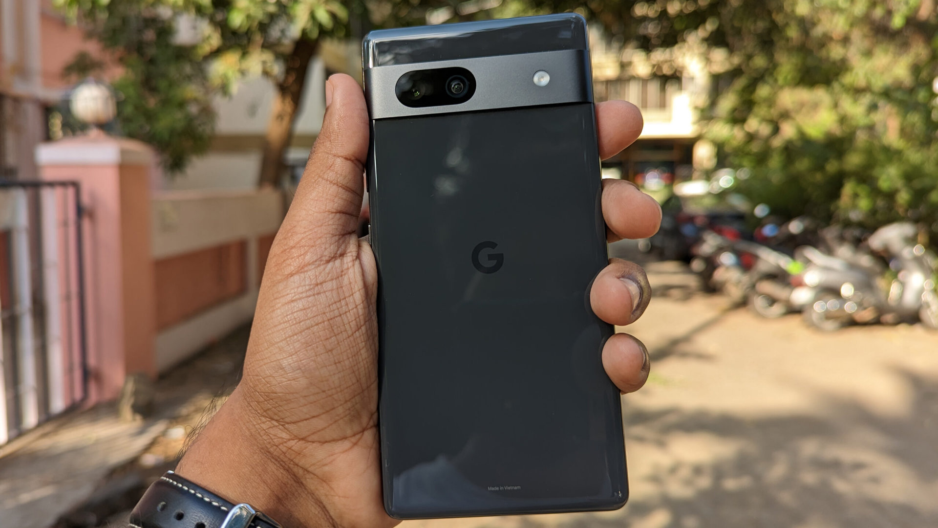 Google Pixel 7a in black outstretched in hand